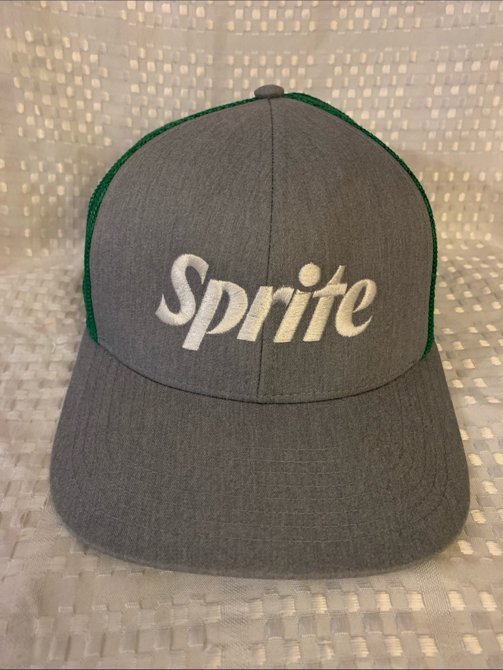 Sprite Grey and Green cap , mesh at the back. Adjustable snap back closure.